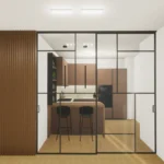 Cucina Veneta Cucine separata dal soggiorno mediante parete vetrata scorrevole progettata per un ambiente luminoso e funzionale.